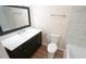 Bathroom with vanity and marble countertop with a tile shower and tub at 909 Windcrest Rd, Durham, NC 27713