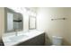 Modern bathroom vanity with a sink and mirror at 909 Windcrest Rd, Durham, NC 27713