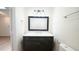 Updated bathroom vanity with marble countertop and chrome fixtures, plus large mirror at 909 Windcrest Rd, Durham, NC 27713