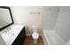 Bathroom boasts a sleek vanity with marble countertop, plus a modern tiled shower-tub combination at 909 Windcrest Rd, Durham, NC 27713
