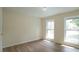 Bright bedroom with updated flooring and two large windows at 909 Windcrest Rd, Durham, NC 27713