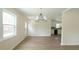 Open-concept dining area with wood floors, a view to the kitchen and natural light at 909 Windcrest Rd, Durham, NC 27713
