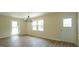 Bright dining room with modern lighting fixture, natural light, and wood-look floors at 909 Windcrest Rd, Durham, NC 27713