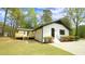 Rear exterior view showcasing the home's fresh paint, new deck, and nicely landscaped yard at 909 Windcrest Rd, Durham, NC 27713