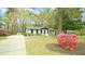 Charming single-story home featuring a well-manicured lawn and blooming azalea bushes at 909 Windcrest Rd, Durham, NC 27713