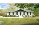 Charming exterior with white brick, black trim, landscaped front yard, and inviting entrance at 909 Windcrest Rd, Durham, NC 27713