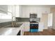 Modern kitchen features white cabinets, stainless steel appliances, and beautiful countertops at 909 Windcrest Rd, Durham, NC 27713