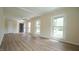 Spacious room with wood-look floors, many windows, and a ceiling fan at 909 Windcrest Rd, Durham, NC 27713