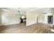 Open-concept living area with wood-look floors, leading to the kitchen, with bright lighting at 909 Windcrest Rd, Durham, NC 27713