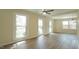 Open living area with wood-look floors, natural light, and a modern ceiling fan at 909 Windcrest Rd, Durham, NC 27713