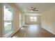 Bright living room with wood-look floors and plenty of natural light from large windows at 909 Windcrest Rd, Durham, NC 27713