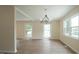Inviting living room with wood floors, modern chandelier and large windows at 909 Windcrest Rd, Durham, NC 27713