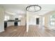 Open concept living space with updated kitchen and view to dining room at 909 Windcrest Rd, Durham, NC 27713