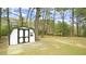 The backyard has a small storage shed and is heavily wooded at 909 Windcrest Rd, Durham, NC 27713