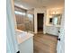 Bright bathroom with a glass enclosed shower, double vanity, and wood look floors at 91 Brooklynn Trl # 187, Angier, NC 27501