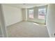 Bright bedroom with neutral carpet, white walls, two windows providing ample natural light at 91 Brooklynn Trl # 187, Angier, NC 27501