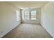 Bedroom featuring neutral carpet, white walls, and two windows offering plenty of natural light at 91 Brooklynn Trl # 187, Angier, NC 27501