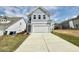 Charming two-story home with light blue siding and a spacious two-car garage on a sunny day at 91 Brooklynn Trl # 187, Angier, NC 27501
