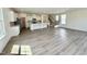 Spacious living room featuring an open layout, modern flooring, a kitchen island, and a staircase at 91 Brooklynn Trl # 187, Angier, NC 27501