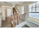 Staircase with wooden handrails and black balusters, complemented by natural light from nearby windows at 91 Brooklynn Trl # 187, Angier, NC 27501