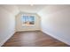 This bedroom features wood-look flooring and a bright window at 9512 Wood River Dr, Zebulon, NC 27597
