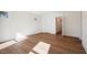 Empty bedroom with luxury vinyl floors, white walls, trim, and doors, with natural light coming from a window at 9512 Wood River Dr, Zebulon, NC 27597