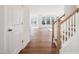 Bright and spacious living room with hardwood floors, and staircase with wood banister and white risers at 9512 Wood River Dr, Zebulon, NC 27597
