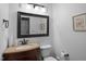 This bathroom features a wooden vanity, toilet and decorative artwork adding sophistication to the space at 989 Ambergate Sta, Apex, NC 27502