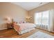 Bright bedroom with vaulted ceilings, wooden floors, and a queen sized bed covered in pink linens at 989 Ambergate Sta, Apex, NC 27502