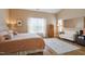 Bright bedroom with vaulted ceilings, wooden floors, with a queen sized bed and sitting area at 989 Ambergate Sta, Apex, NC 27502