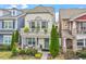 Charming two-story home features a balcony, landscaped yard, and inviting front porch with seating at 989 Ambergate Sta, Apex, NC 27502