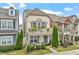 Charming two-story townhouse with a balcony, well-manicured lawn, and cozy front porch at 989 Ambergate Sta, Apex, NC 27502