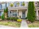 Well-kept front yard and home exterior, featuring a cozy porch and lush plantings at 989 Ambergate Sta, Apex, NC 27502