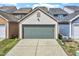 Detached two-car garage with neutral siding and a gray door at 989 Ambergate Sta, Apex, NC 27502