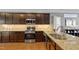 Spacious kitchen with stainless steel appliances and island, open to the living area at 989 Ambergate Sta, Apex, NC 27502
