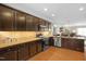 Modern kitchen with stainless steel appliances, granite countertops, and dark wood cabinetry at 989 Ambergate Sta, Apex, NC 27502