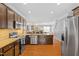 Modern kitchen with stainless steel appliances and open concept design leading to living area at 989 Ambergate Sta, Apex, NC 27502