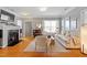 Spacious living room with hardwood floors, neutral furniture, and a view of the fireplace at 989 Ambergate Sta, Apex, NC 27502