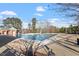Community pool featuring a lifeguard building, trees, and nearby lounge chairs at 989 Ambergate Sta, Apex, NC 27502