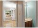 View of a bathroom vanity and mirror, with doorway view into dining area with a window at 1003 Buckhorn Rd, Garner, NC 27529