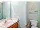 Bright bathroom features a modern toilet, vanity, and sink with decorative wall art at 1003 Buckhorn Rd, Garner, NC 27529