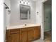 Bathroom features a large vanity, mirror, light fixture, and view into shower/tub at 1003 Buckhorn Rd, Garner, NC 27529