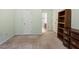 Bedroom with neutral carpet, trim, and view into en-suite bathroom at 1003 Buckhorn Rd, Garner, NC 27529