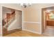 View of stairs, kitchen, and eating area from a dining room with hardwood floors at 1003 Buckhorn Rd, Garner, NC 27529