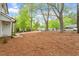 Expansive front yard with mature trees leading up to a charming traditional home with a long driveway at 1003 Buckhorn Rd, Garner, NC 27529