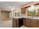 Cozy kitchen featuring classic wooden cabinets, white countertops, a built-in dishwasher, and ample natural light at 1003 Buckhorn Rd, Garner, NC 27529