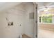 Laundry room with shelving and tile floor, located adjacent to bright eating area at 1003 Buckhorn Rd, Garner, NC 27529