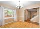 Open-concept living room boasts hardwood floors, large windows, and staircase access at 1003 Buckhorn Rd, Garner, NC 27529