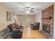 Cozy living room features a brick fireplace, hardwood floors, and lots of natural light at 1003 Buckhorn Rd, Garner, NC 27529