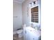 Bathroom featuring a white vanity, modern lighting, toilet and decorative mirror at 10095 N Walnut St St, Middlesex, NC 27557